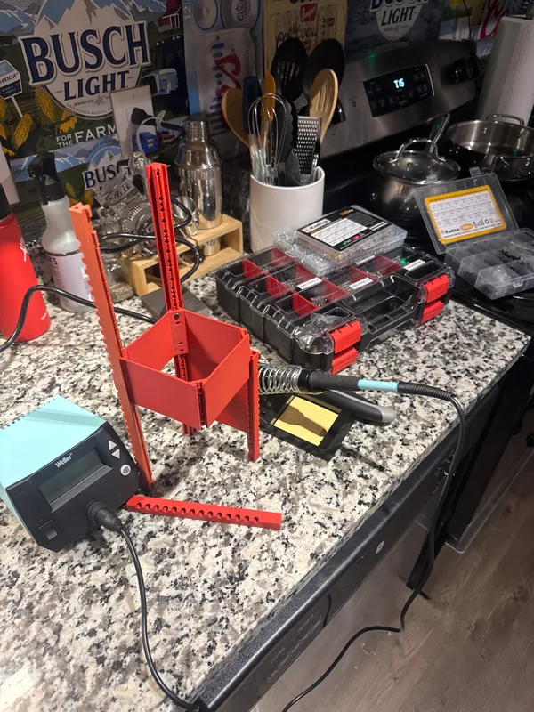 Red and orange frame prototype with rails and an internal mounting section on a work surface.